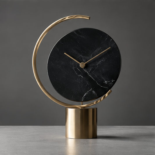 DINOVIR black marble-effect dial clock with gold-tone hands and open ring on a cylindrical base against a plain gray background