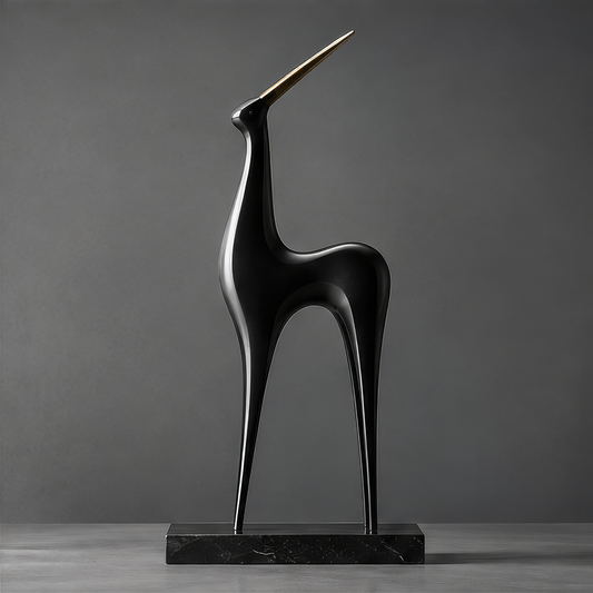 DINOVIR abstract black animal sculpture with elongated legs and a single gold-tone horn on a rectangular base against a plain gray background