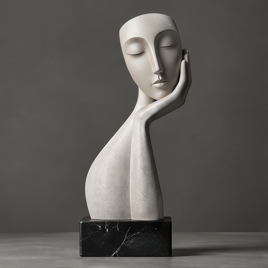 DINOVIR off-white abstract closed-eye face resting on a hand above a black rectangular base, against a plain gray background